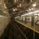 Looking out the back of the train pulling out of a station